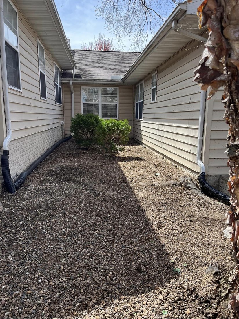 Cleared planting bed beside a home